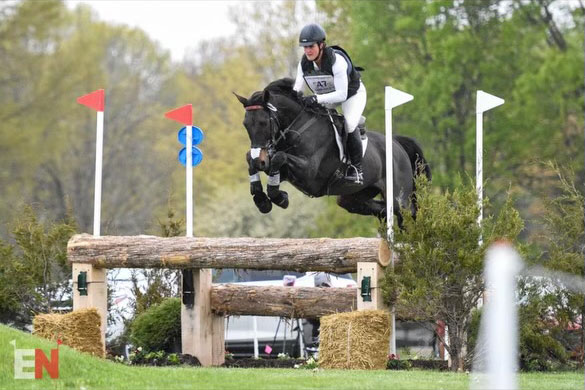 GW Law alumn Ema Klugman rides her horse as it jumps a hurdle during competition.