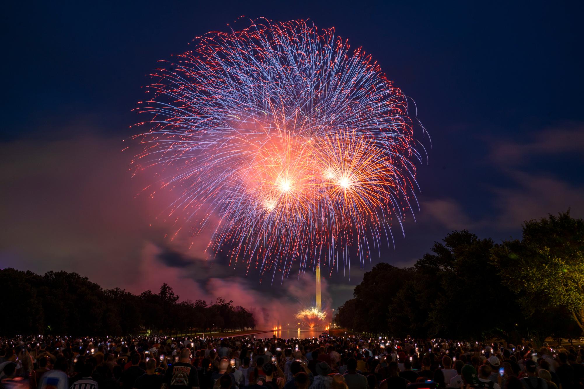 Fireworks explode over the Reflecting Pool during Washington D.C.'s annual Independence Day celebration.