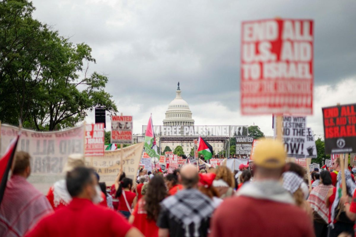 The United States Capitol looms over the crowd of demonstrators on Pennsylvania Avenue.