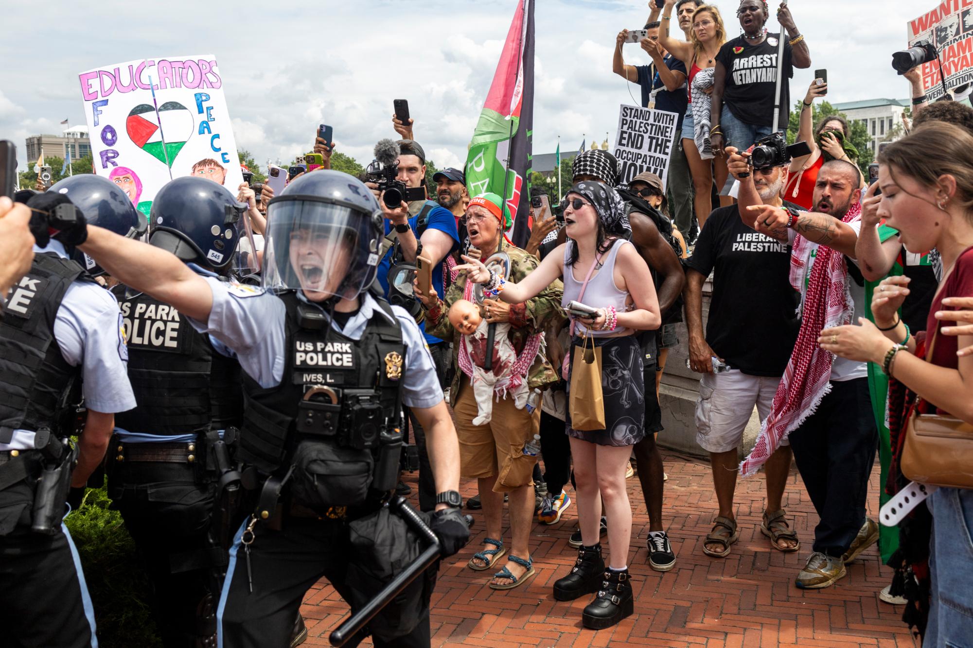 U.S. Park Police pepper spray a crowd of protestors as they arrest demonstrators who removed the U.S. flag from its post outside Union Station 