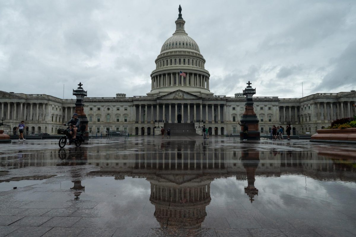 Pools of water left by Hurricane Debby reflect the U.S. Capitol Building