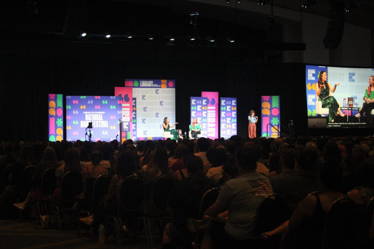 An audience attends an author presentation by Romantic Fantasy Author Rebecca Yarros at the festival's main stage.