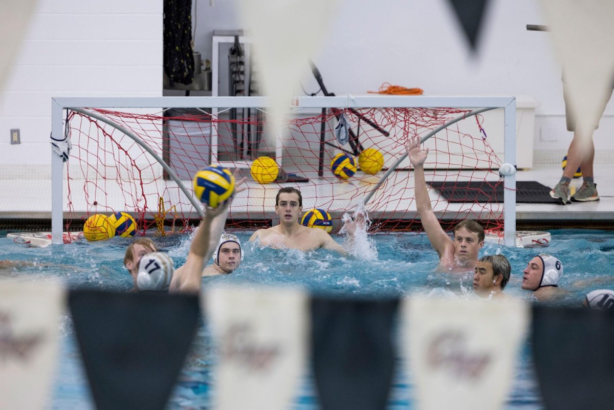 The water polo team practices shots on goal during a practice