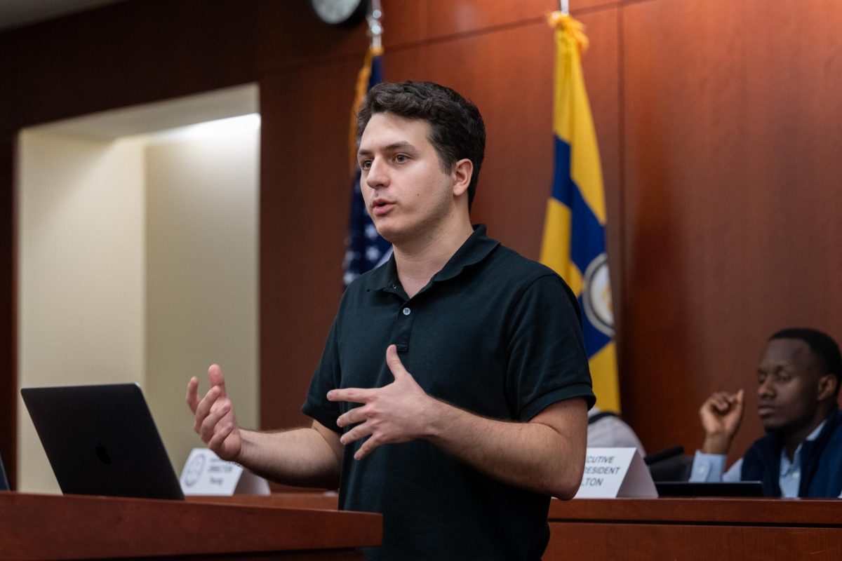 Student Bar Association Sen. Omer Turkomer, chair of the Finance Committee, delivers remarks on the Senate budget proposal during Tuesday's meeting.