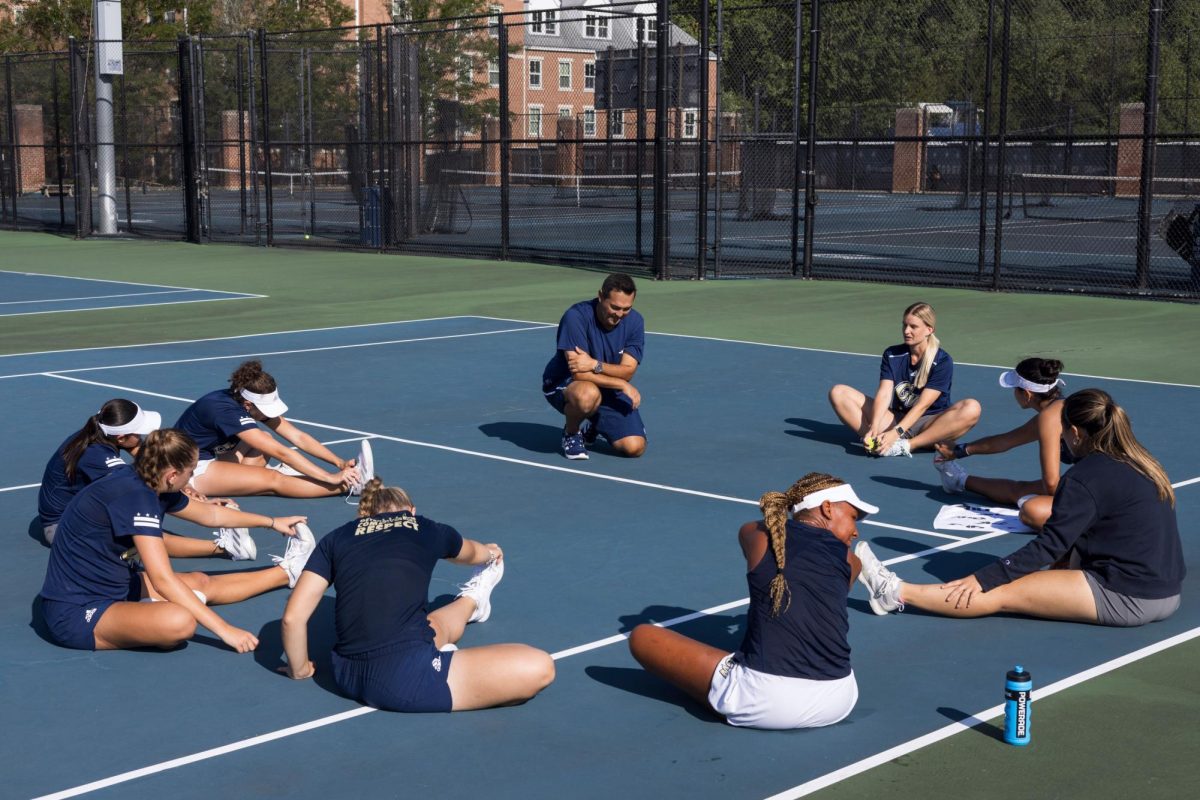 Head Coach George Rodriguez huddles with players during a Thursday practice.