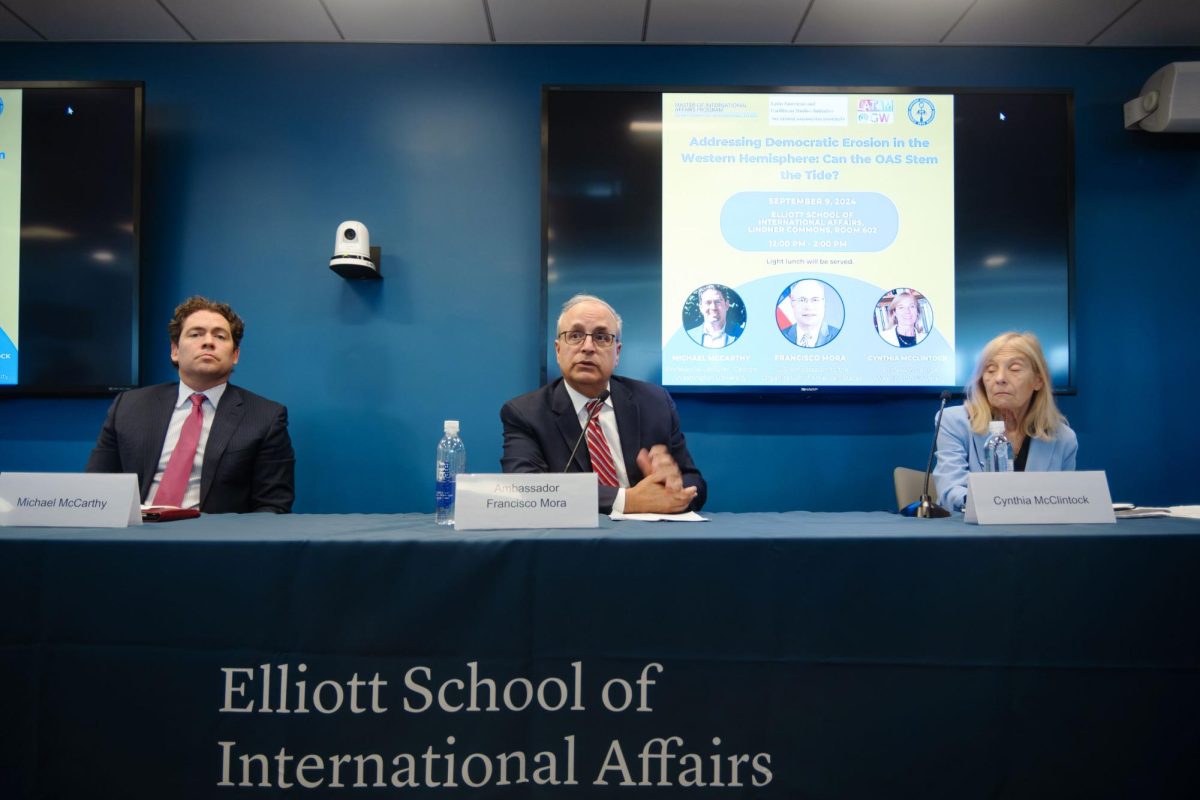 Alongside the other panelists, Ambassador Francisco Mora answers questions during a discussion.