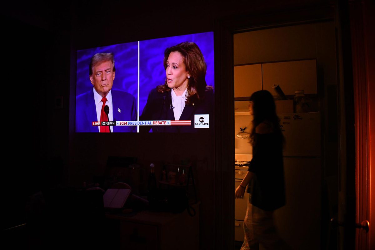 The 2024 Presidential Debate projects onto a wall in a student's room.