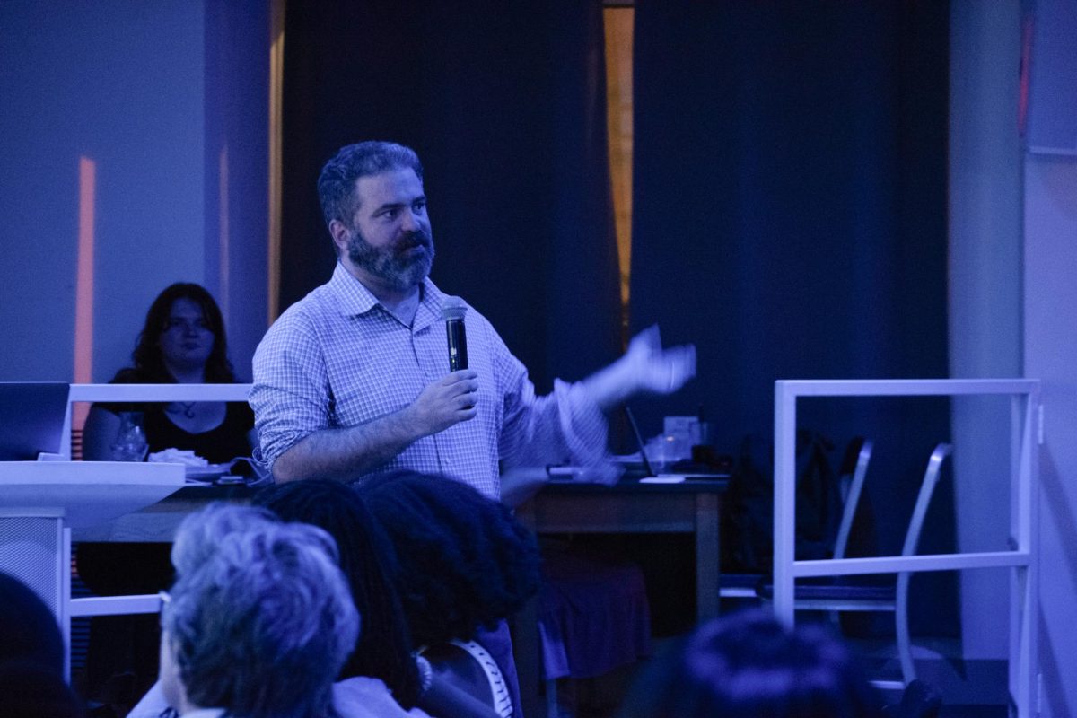 Professor Ethan Porter leads a discussion about political persuasion before the start of the first presidential debate.