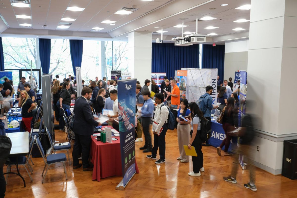 Students browse the various employer booths at the 2024 Fall Career Expo in the University Student Center.