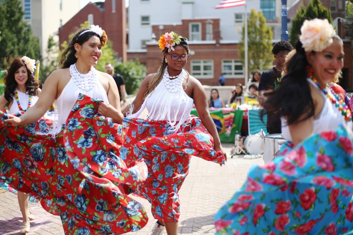 Members of Vavá Samba, a local Brazilian dance organization, perform during the Meet La Familia celebration.