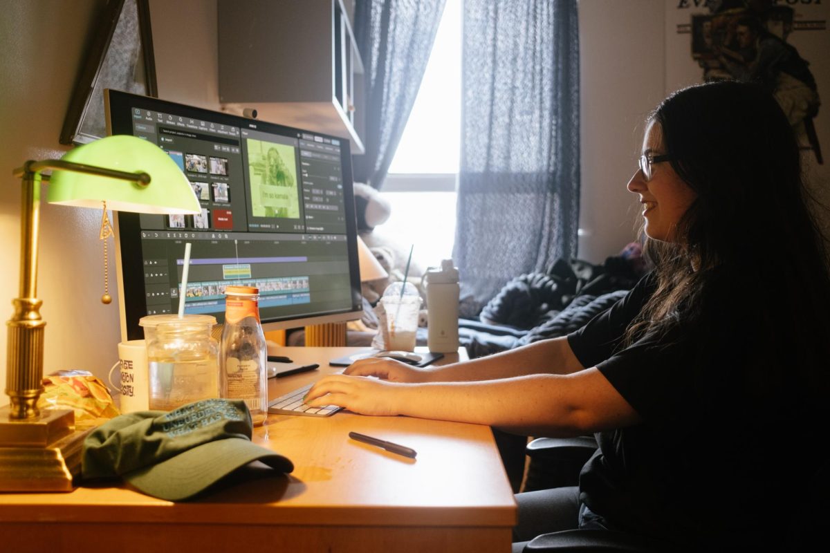 Aly McCormick sits at her computer for a portrait. 