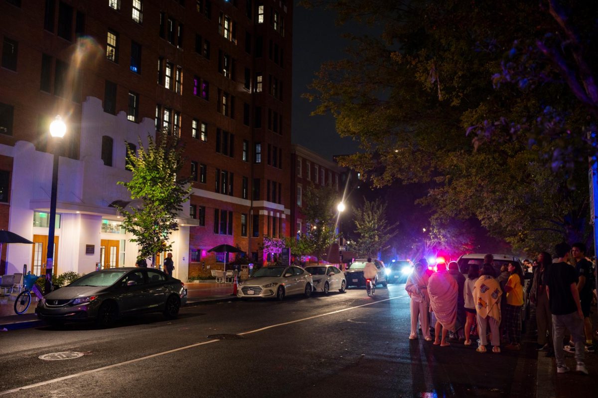 Students stand outside Mabel Nelson Thurston Hall after D.C. Fire and Emergency Medical Services responded to a fire on the fourth floor.