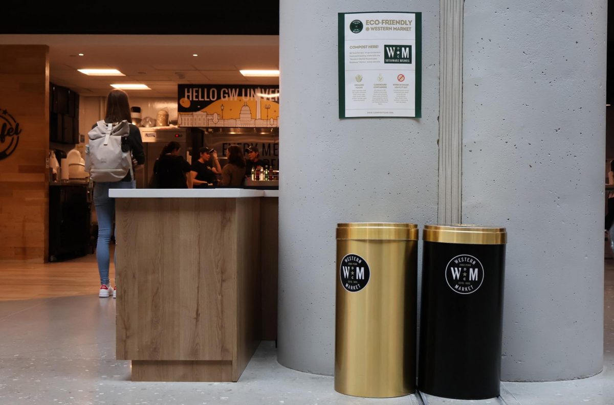 Western Market compost bins located next to a pillar inside of the market