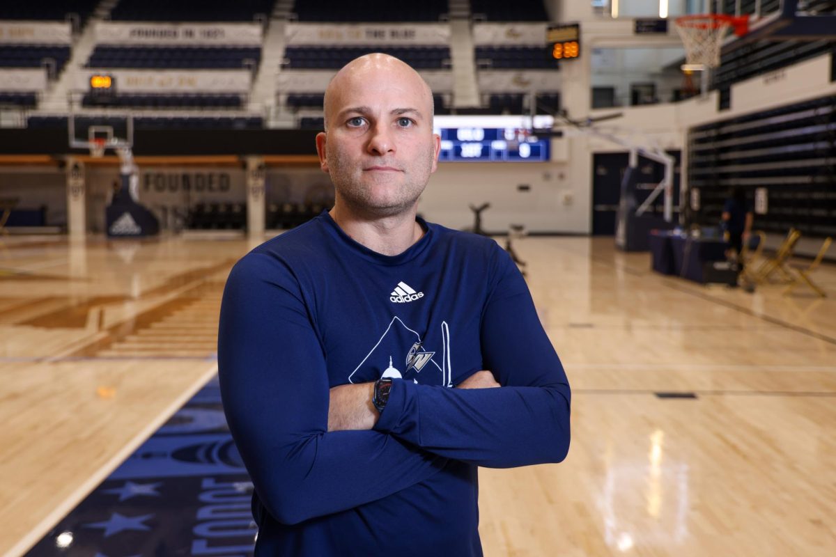 Men's basketball Head Coach Chris Caputo poses for a portrait.