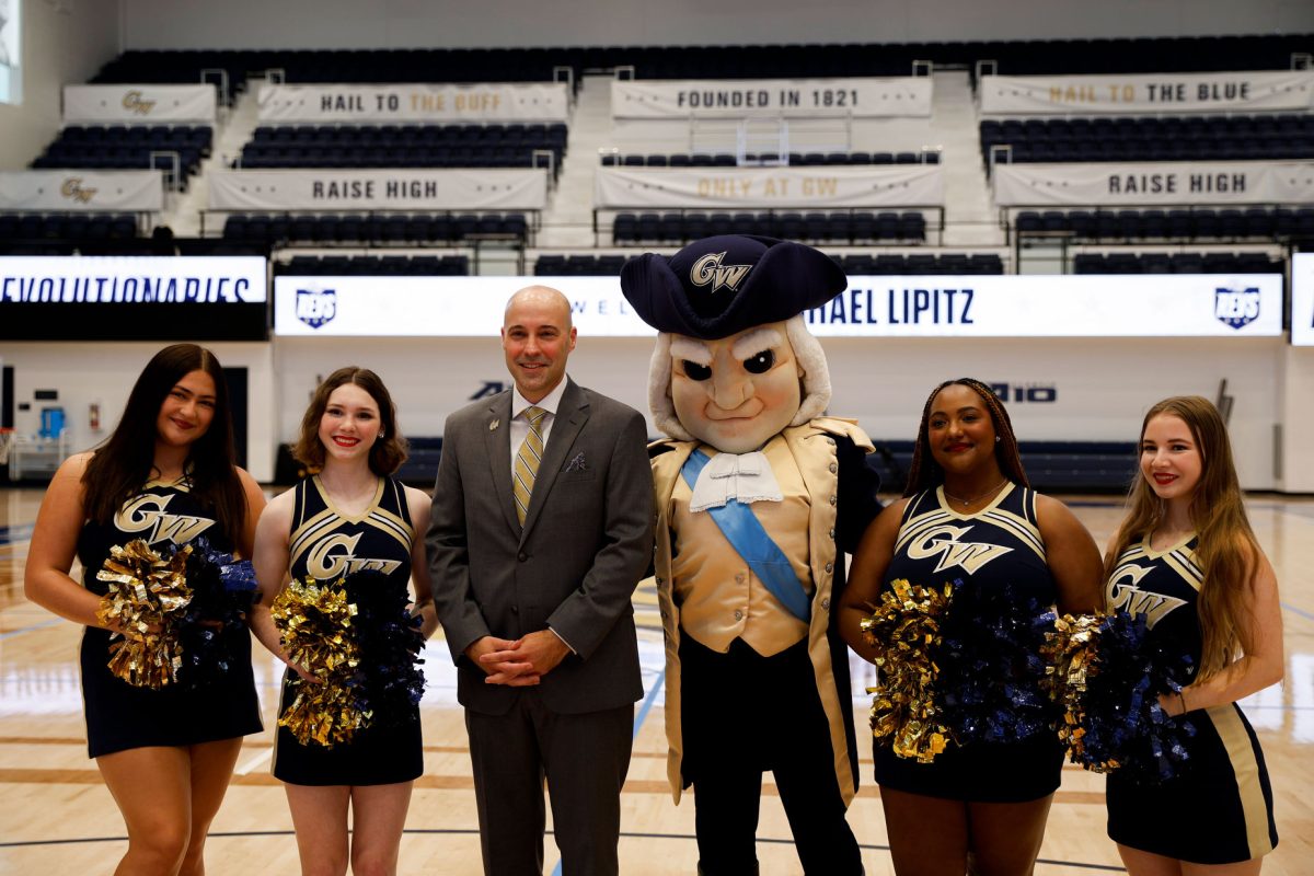 Michael Lipitz poses with GW cheerleaders and George after his introductory event late August