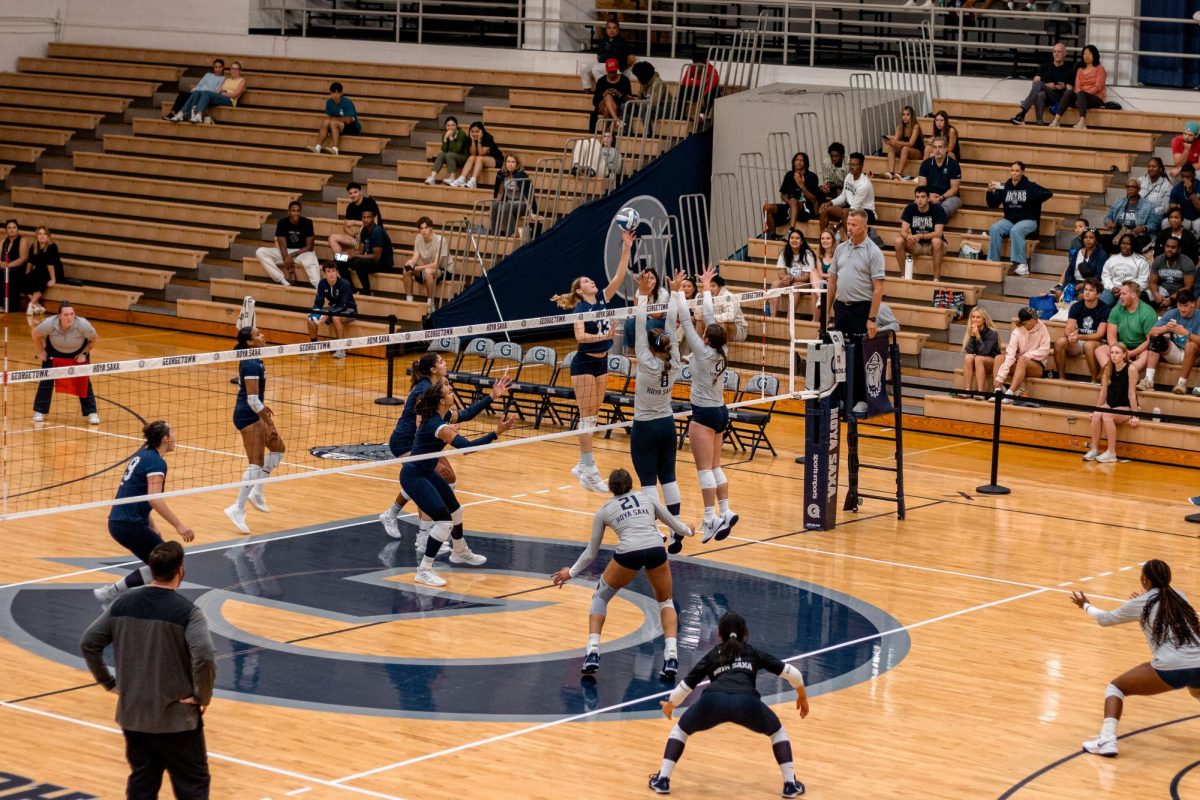 Freshman oppostie Taylor Treahy hits the ball over two Georgetown defenders.