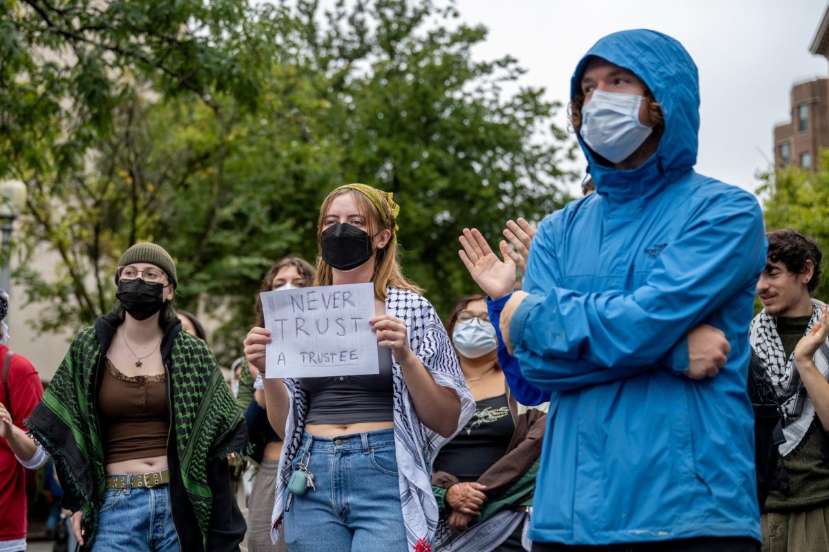 Students protesting the University's Board of Trustees meeting outside the University Student Center this Friday.