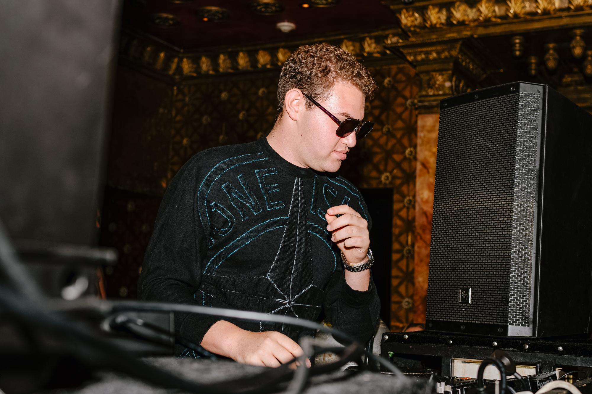 Matthew Kornblau mixes a song with his turntables at Sax Restaurant & Lounge. (Taytum Wymer | Staff Photographer)