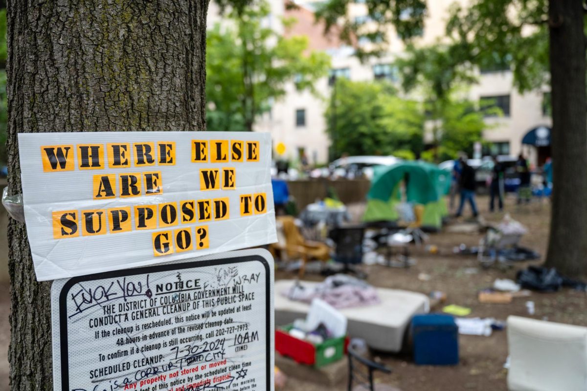 A sign placed next to a notice protesting the sweep of the E Street encampment in July.