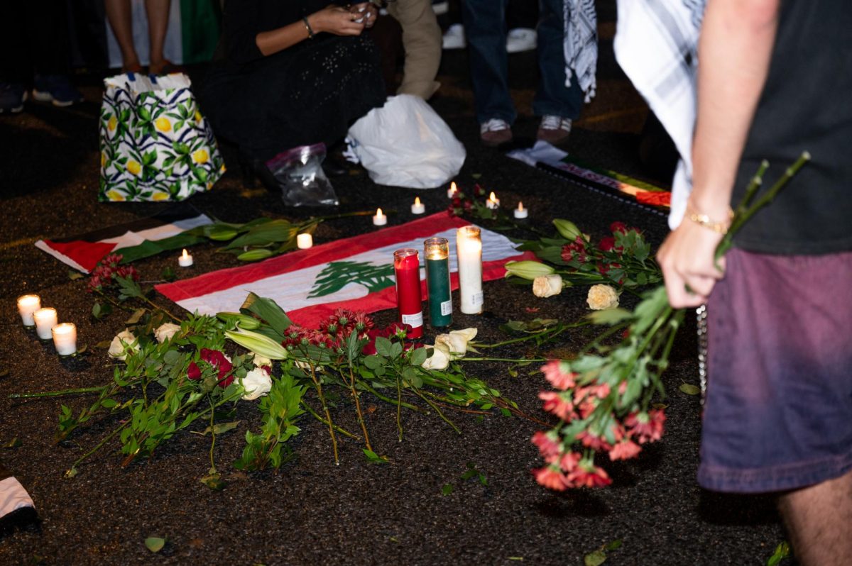 A participant places flowers at the vigil on H Street.