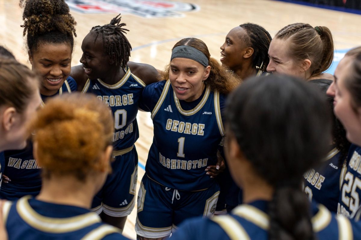 The George Washington Women's Basketball team in a huddle during their first Atlantic 10 championship game in March.