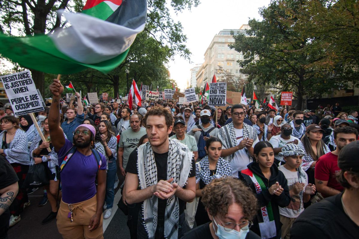 Demonstrators wave flags, clap and march down H street in protest of the war in Gaza.