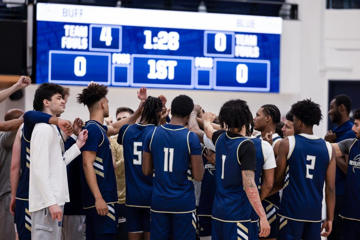 The men's basketball team puts their hands together during a practice earlier this week.