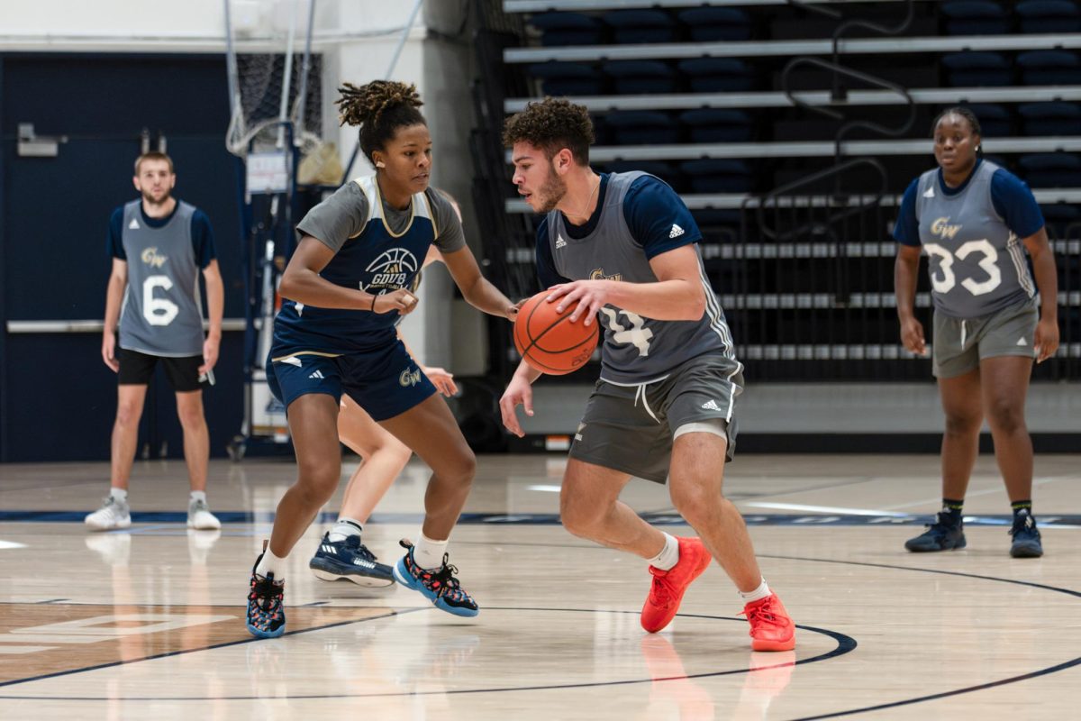 Junior practice player Brady Rosenstock faces off with sophomore forward Sara Lewis during practice.