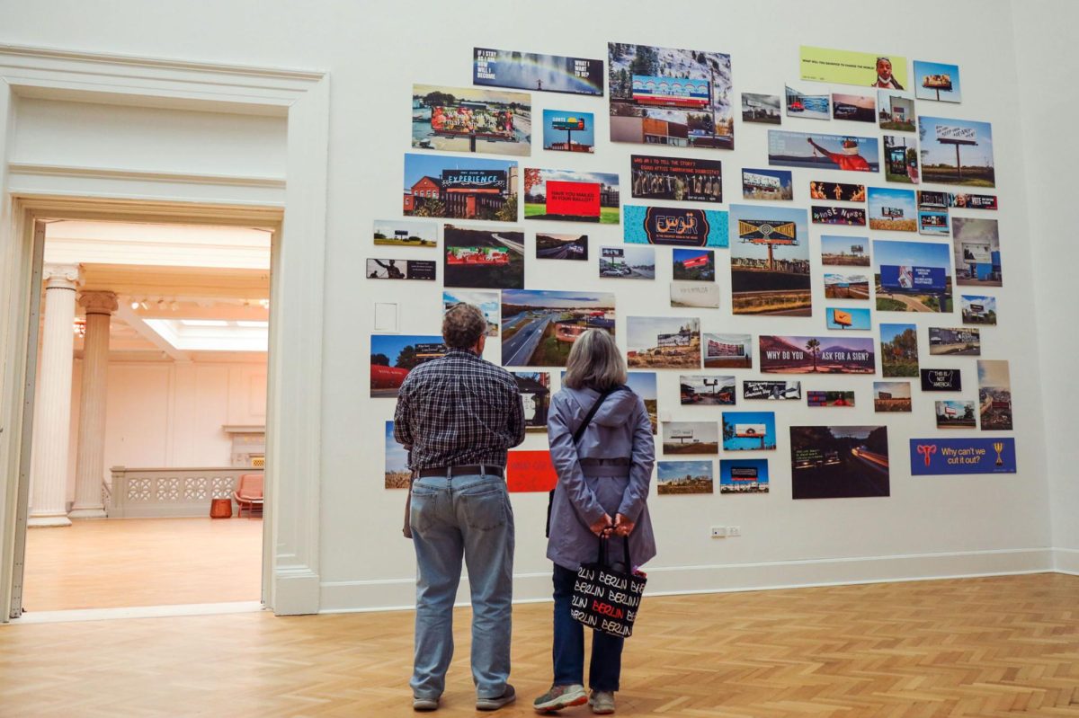 Visitors look at the Billboards exhibit installed in the Corcoran Gallery of Art as part of the For Freedoms residency.