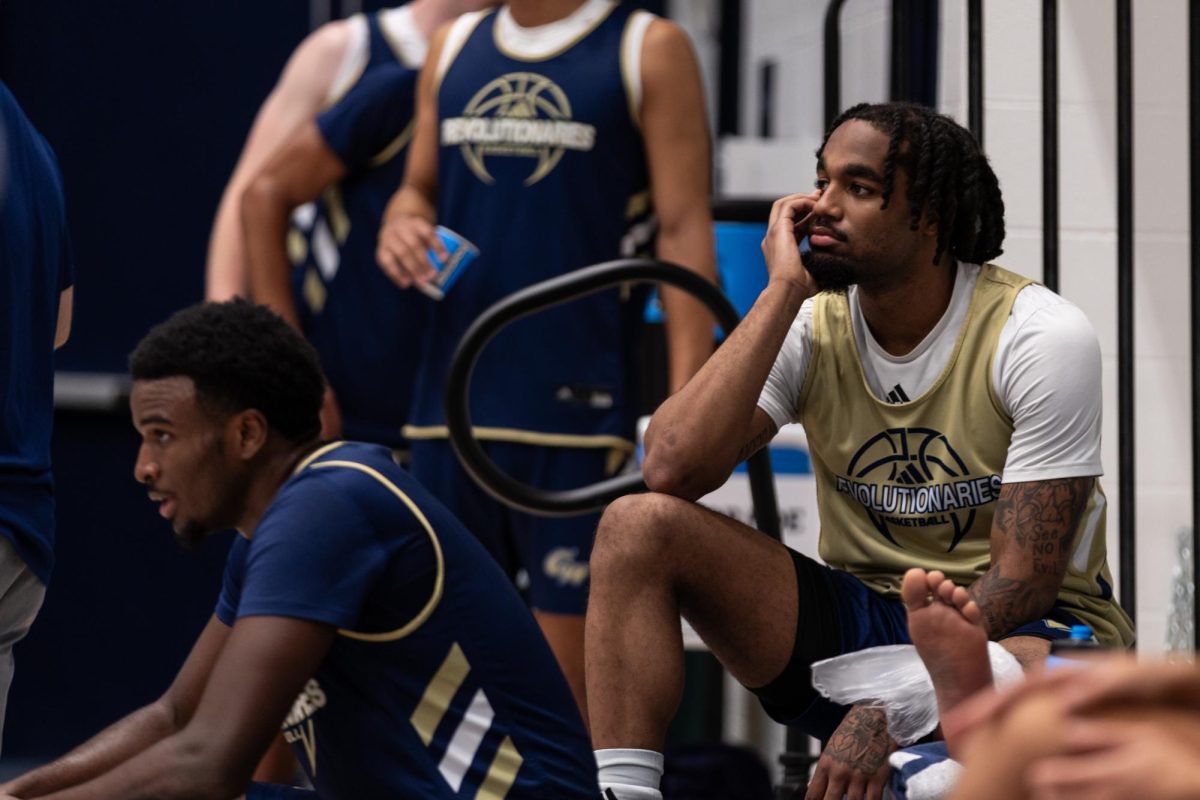 Sophomore guard Jacoi Hutchinson sits on the bleachers during a practice in early October.