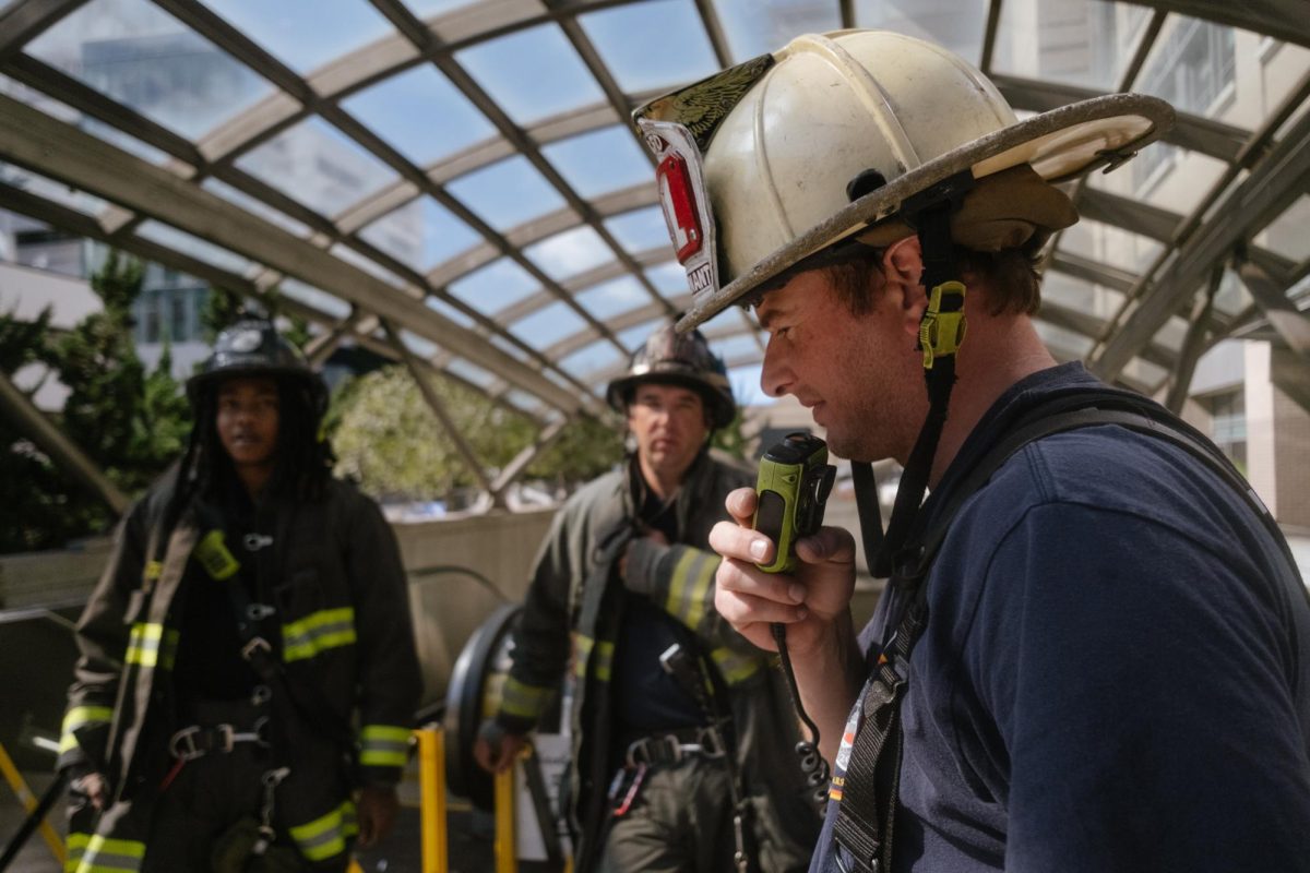 The lieutenant of the DCFD Engine Company No. 11 communicates with other fireman about the situation.