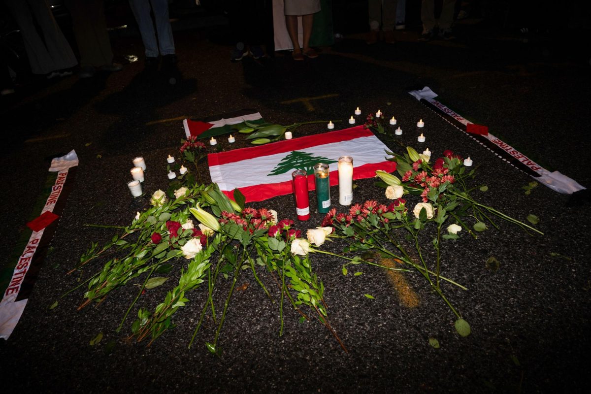 A Lebanese flag lays surrounded by candles and flowers during a vigil hosted in October following Israel's attack.