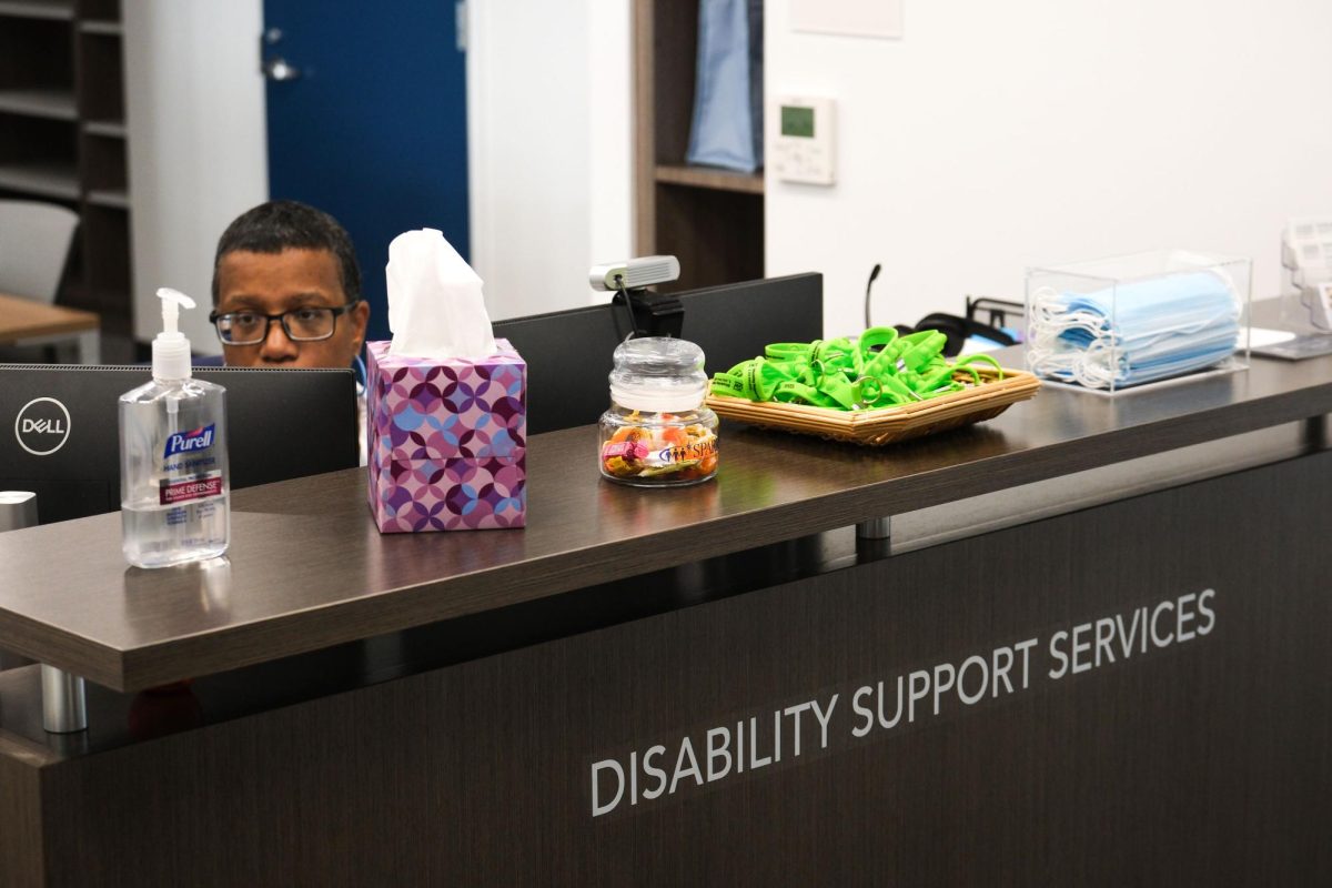 An employee sits at the front desk of the Disability Support Services office on the third floor of the Hillel Building.