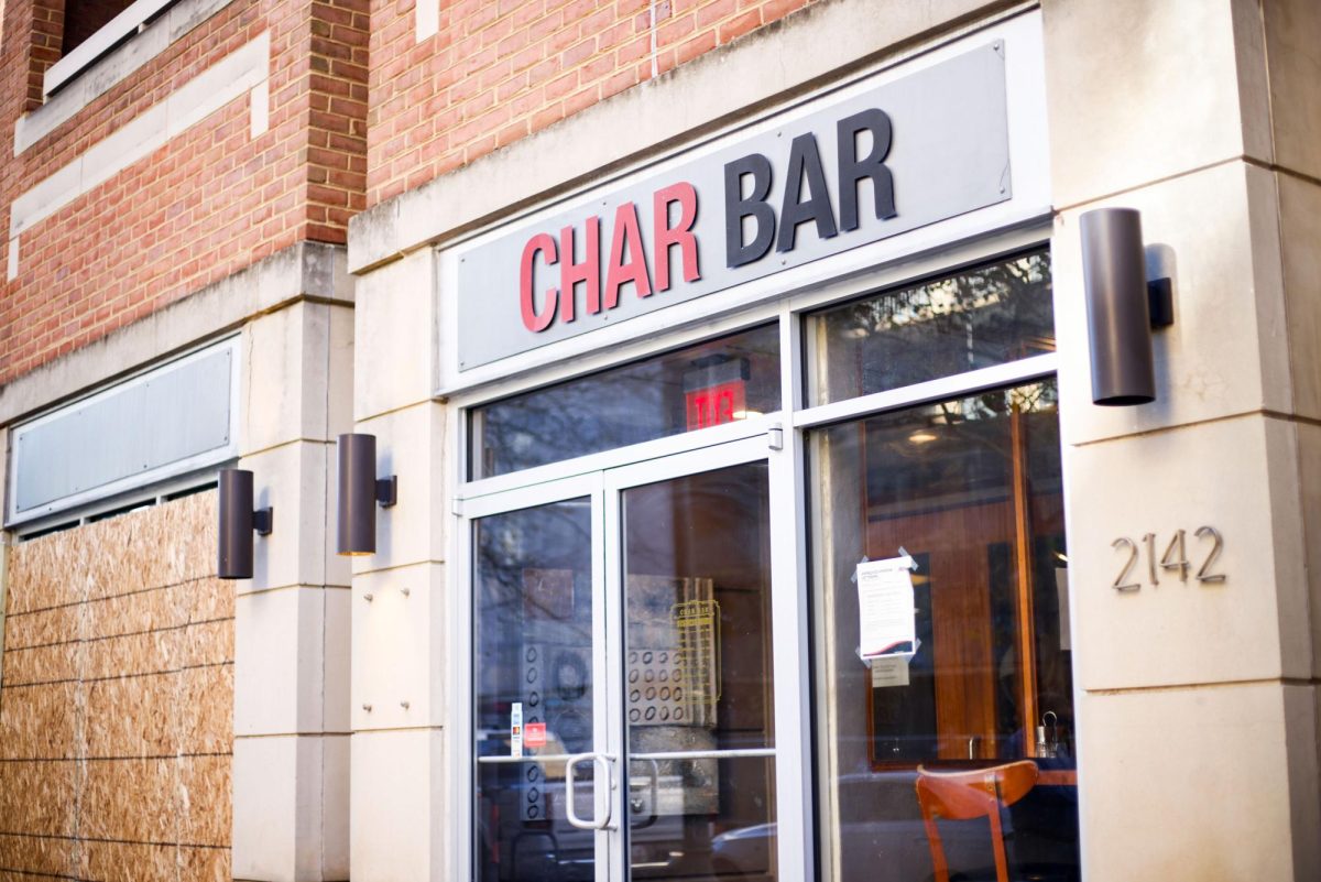 The entrance to Char Bar on L Street, where one window has been boarded up.