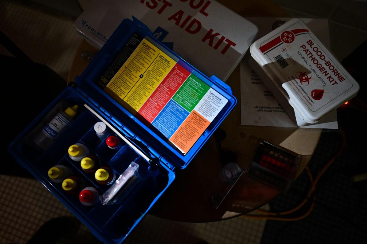 A ph pool testing kit sits open on a table near the pool at the Smith Center.