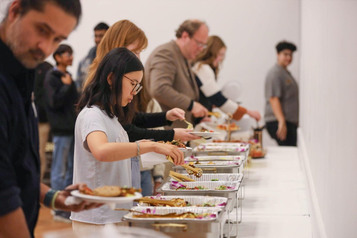 Students grab food during the Interfaith Dinner in the University Student Center Grand Ballroom.