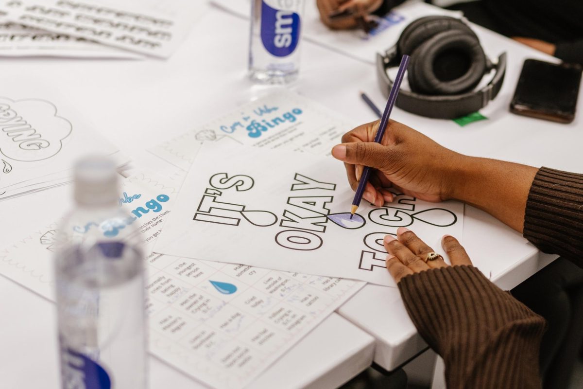 An attendee fills in a self-care coloring sheet.