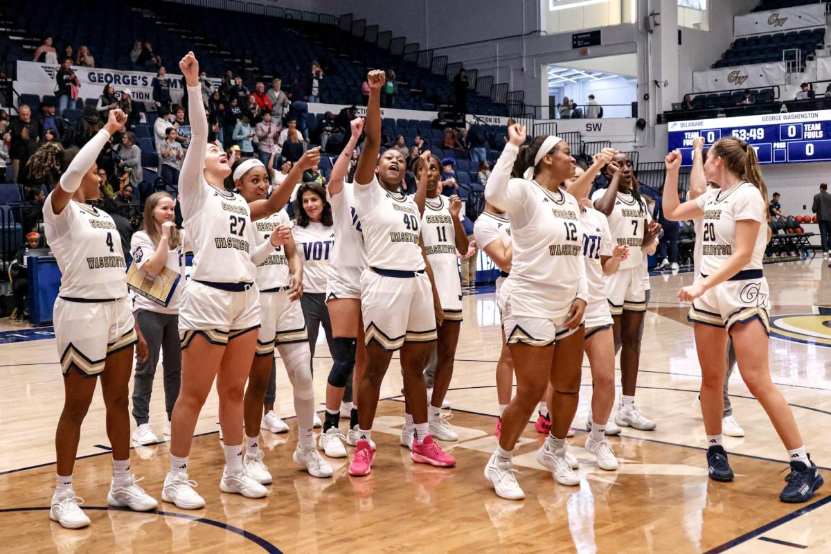 The women's basketball team celebrates their win against Delaware today.