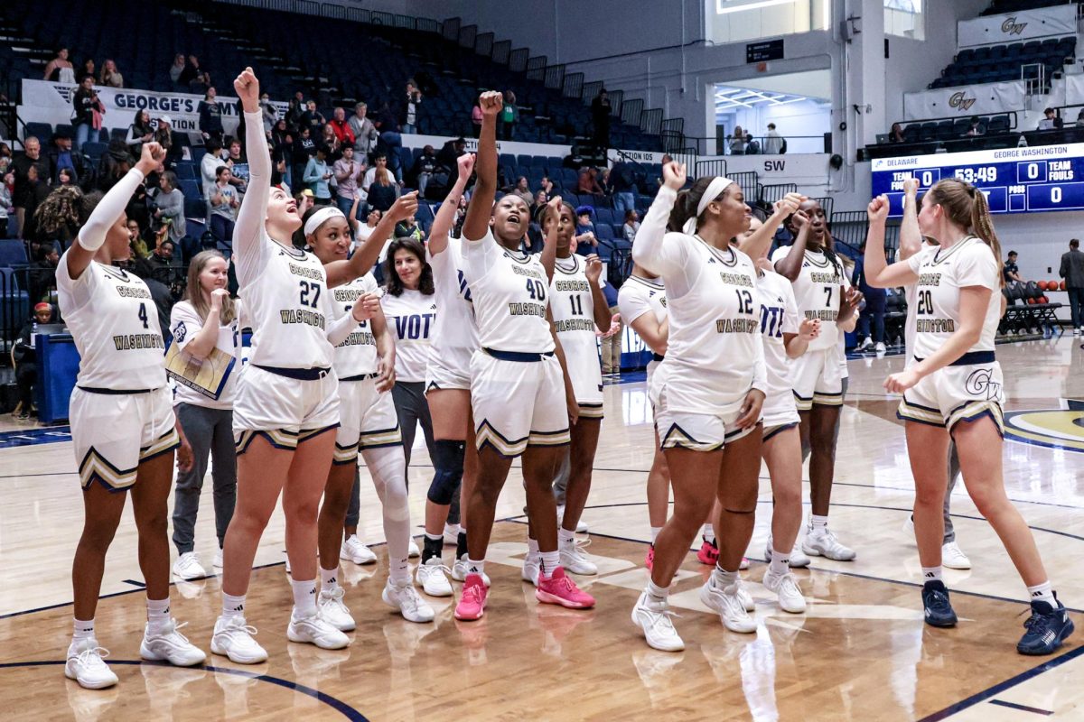 The women's basketball team celebrates their win against Delaware today.