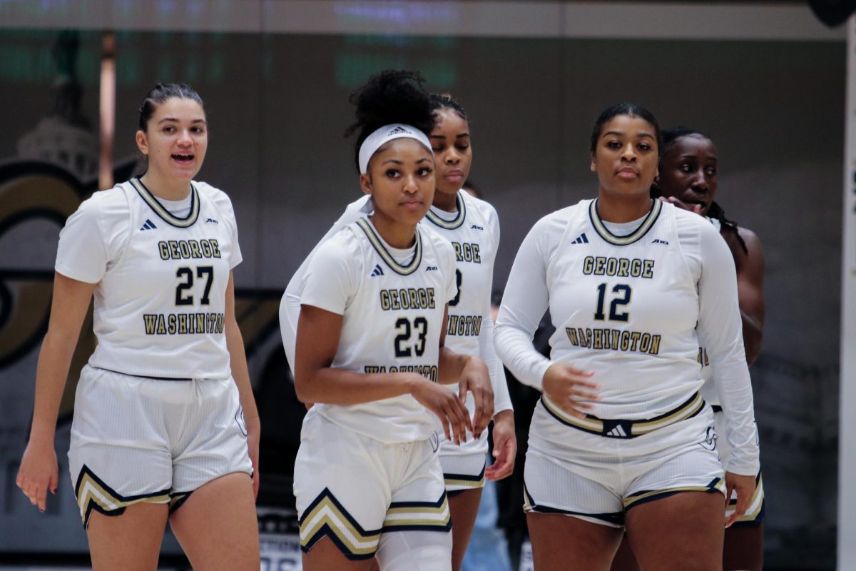 Graduate guard Makayla Andrews stands with teammates Fortuny and Sims during tonights loss against George Mason.