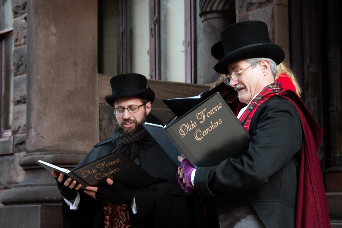 The Olde Towne Carolers sing Christmas carols on the steps of the Heurich House Museum.