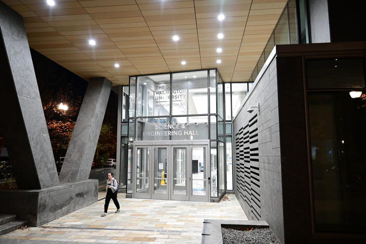 A student exits the Science and Engineering Hall.