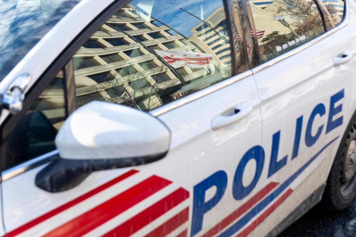 The D.C. flag reflected on the window of a Metropolitan Police Department car.