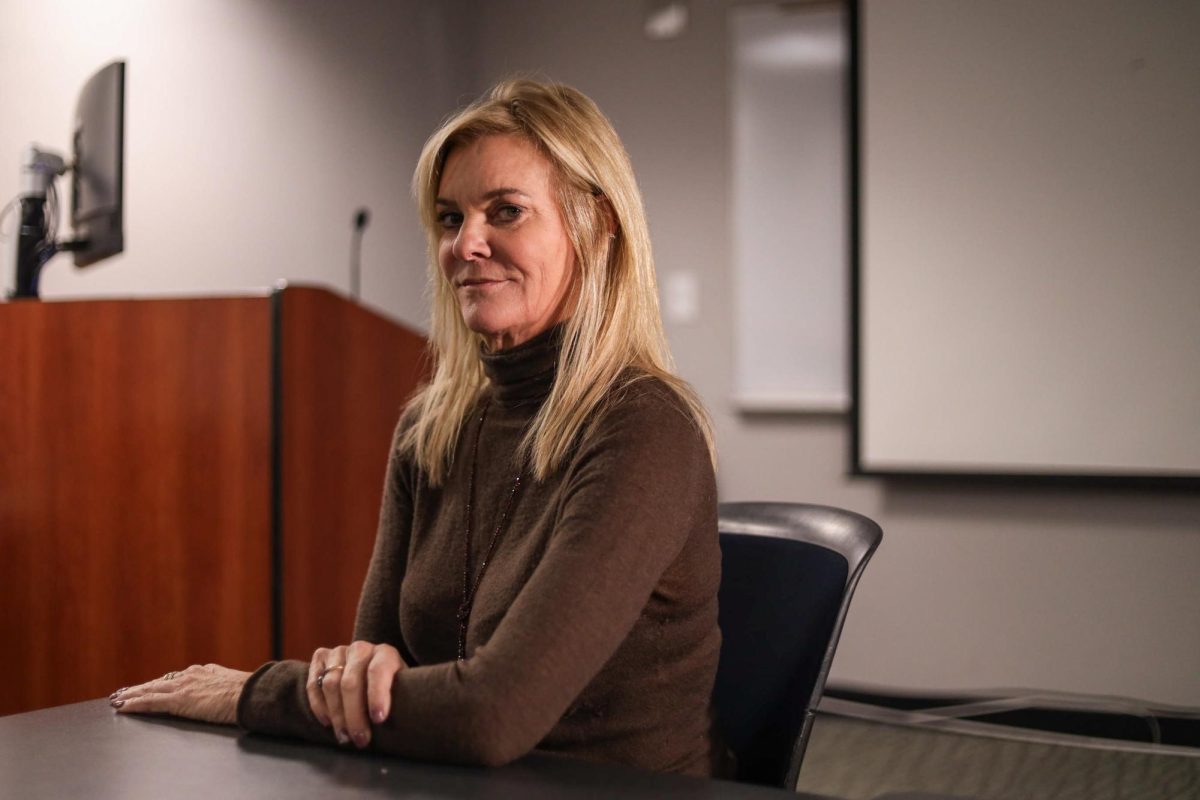 Professor Katharine Weymouth poses for a portrait inside of a classroom in the Media & Public Affairs Building.