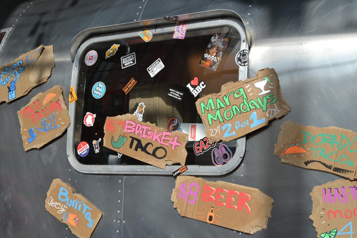 Signs line the airstream trailer inside of the Bodega Taqueria y Tequila.