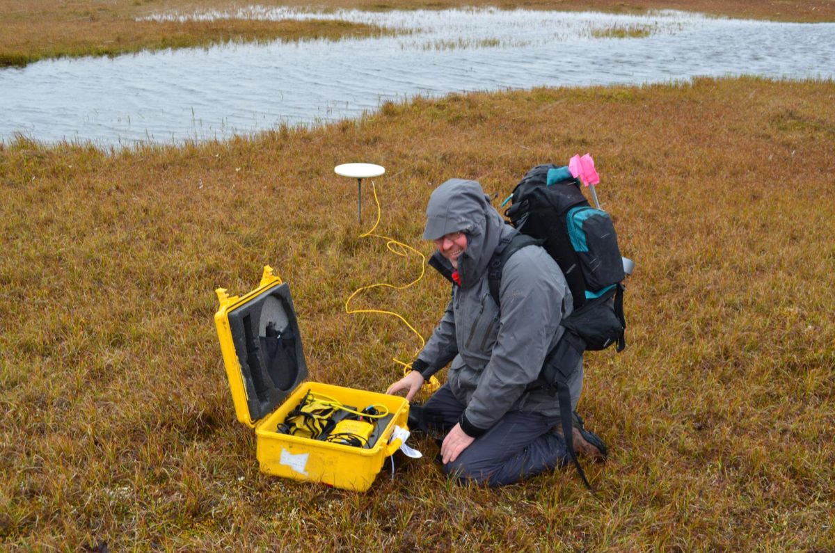 Nikolay Shiklomanov tests the frozen ground in the Arctic.