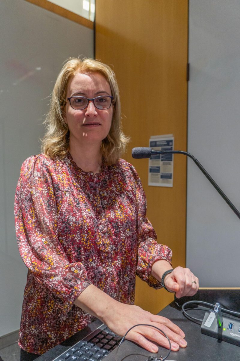 Nadine Rouphael, Executive Director and Professor of Vaccinology and Infectious Diseases at Emory University, stands at the podium after her presentation.