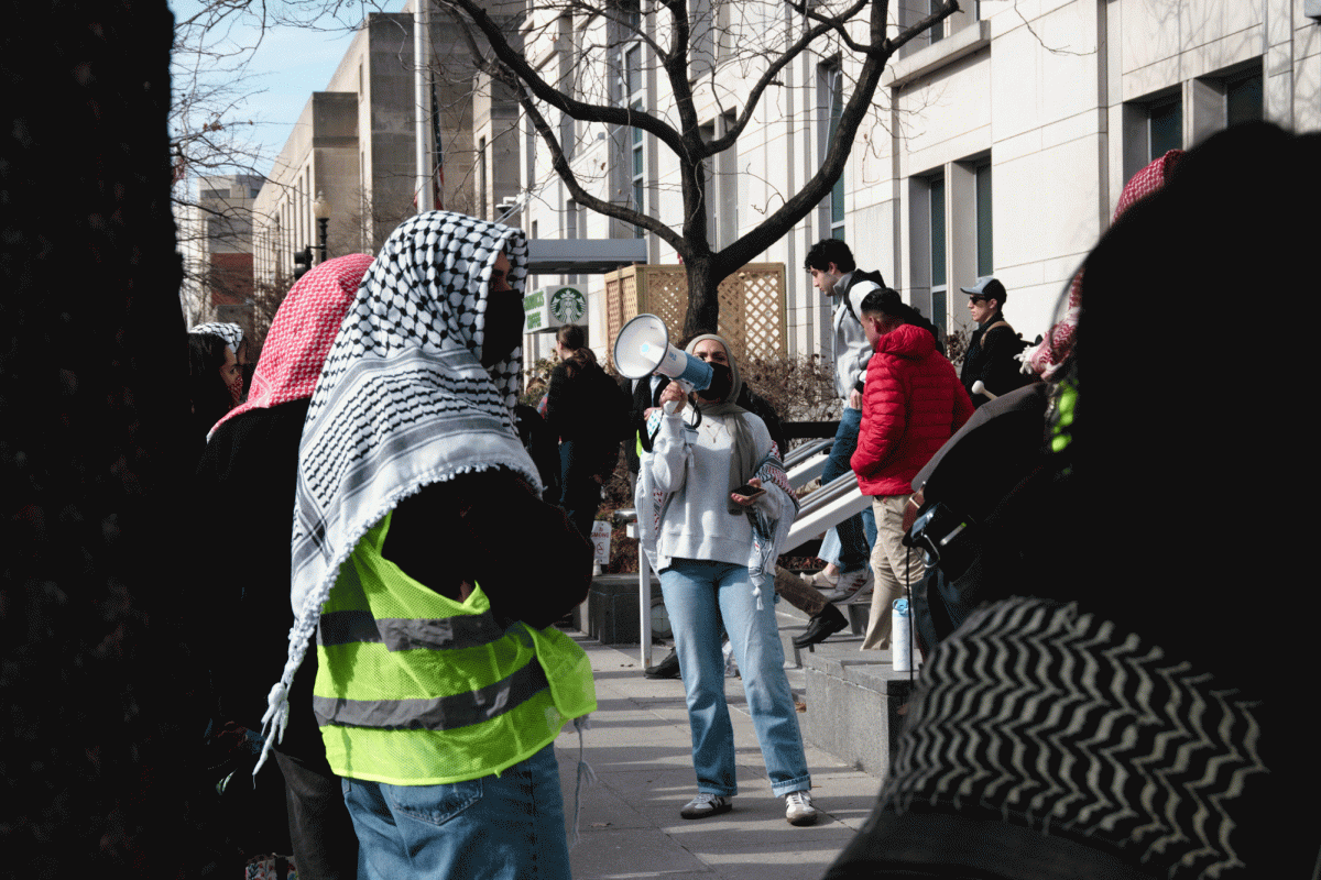 Protesters chant outside of the Elliott School of International Affairs Thursday