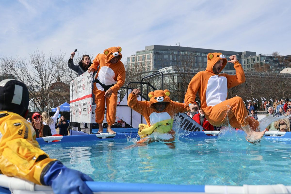 A team of Special Olympics athletes dressed as Rilakkuma the Bear jump into a pool at the 2025 D.C. Polar Plunge.