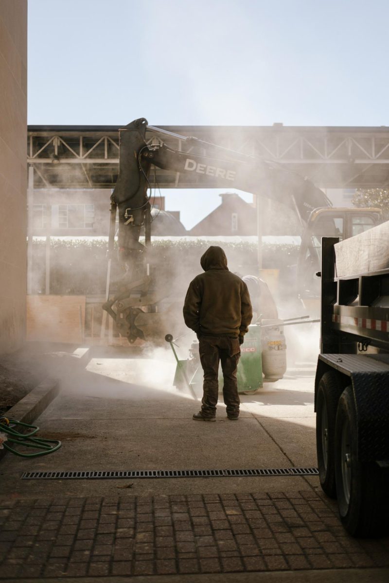 A construction worker oversees drilling at the Lisner Auditorium service parking lot.